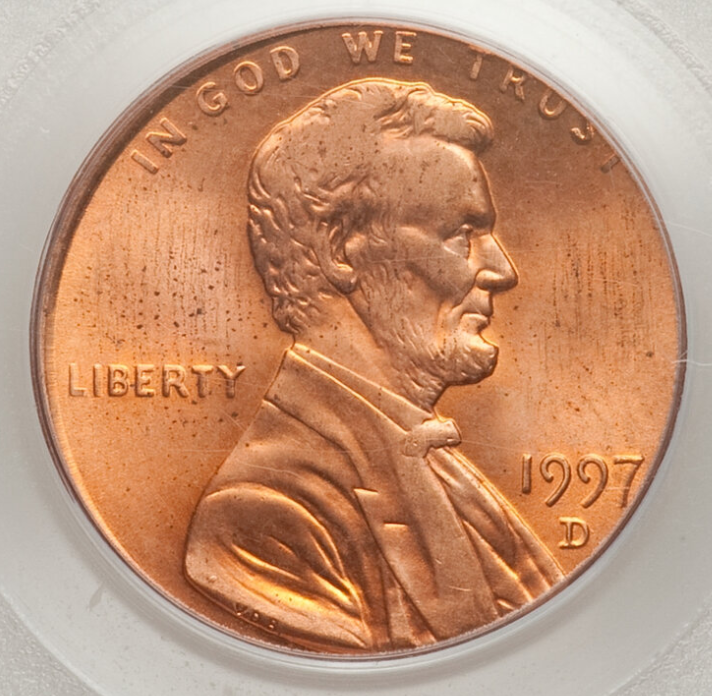 1997 penny struck on wrong planchet showing size and metal color difference compared to a normal Lincoln cent
